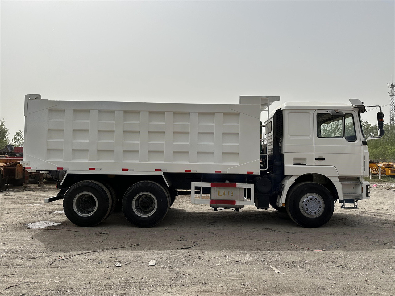 Billenőplatós teherautó a következők szállításához nehézgépek Shacman F3000: 9 kép.