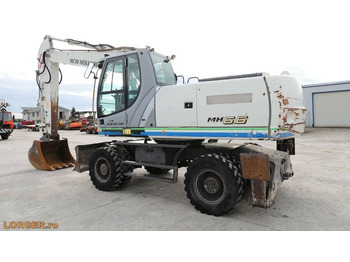Gumikerekes kotró New Holland MH 6.6 + Sandvic Hammer: 3 kép.