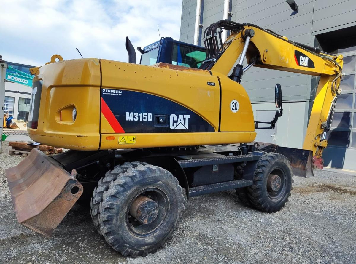 Caterpillar M315D - Gumikerekes kotró: 4 kép. Caterpillar M315D - Gumikerekes kotró: 4 kép.