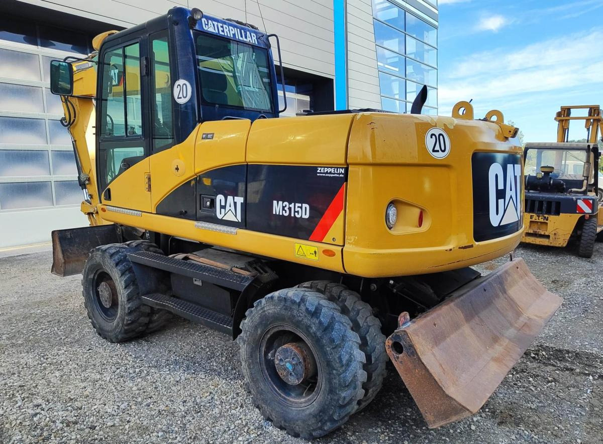 Caterpillar M315D - Gumikerekes kotró: 1 kép. Caterpillar M315D - Gumikerekes kotró: 1 kép.