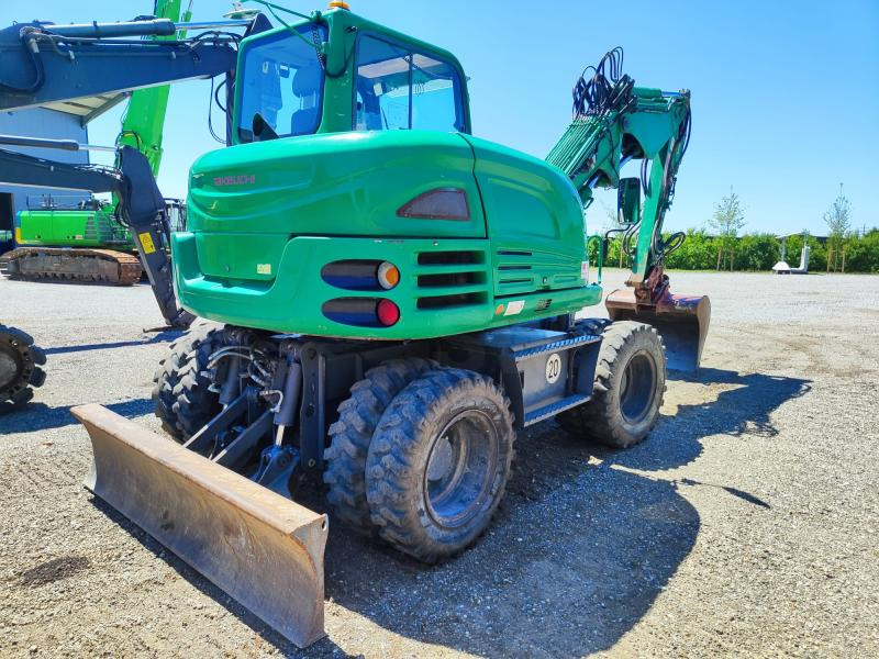Takeuchi TB295W - Gumikerekes kotró: 4 kép. Takeuchi TB295W - Gumikerekes kotró: 4 kép.