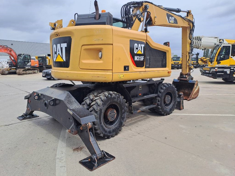 Cat M 315 F - Gumikerekes kotró: 4 kép. Cat M 315 F - Gumikerekes kotró: 4 kép.