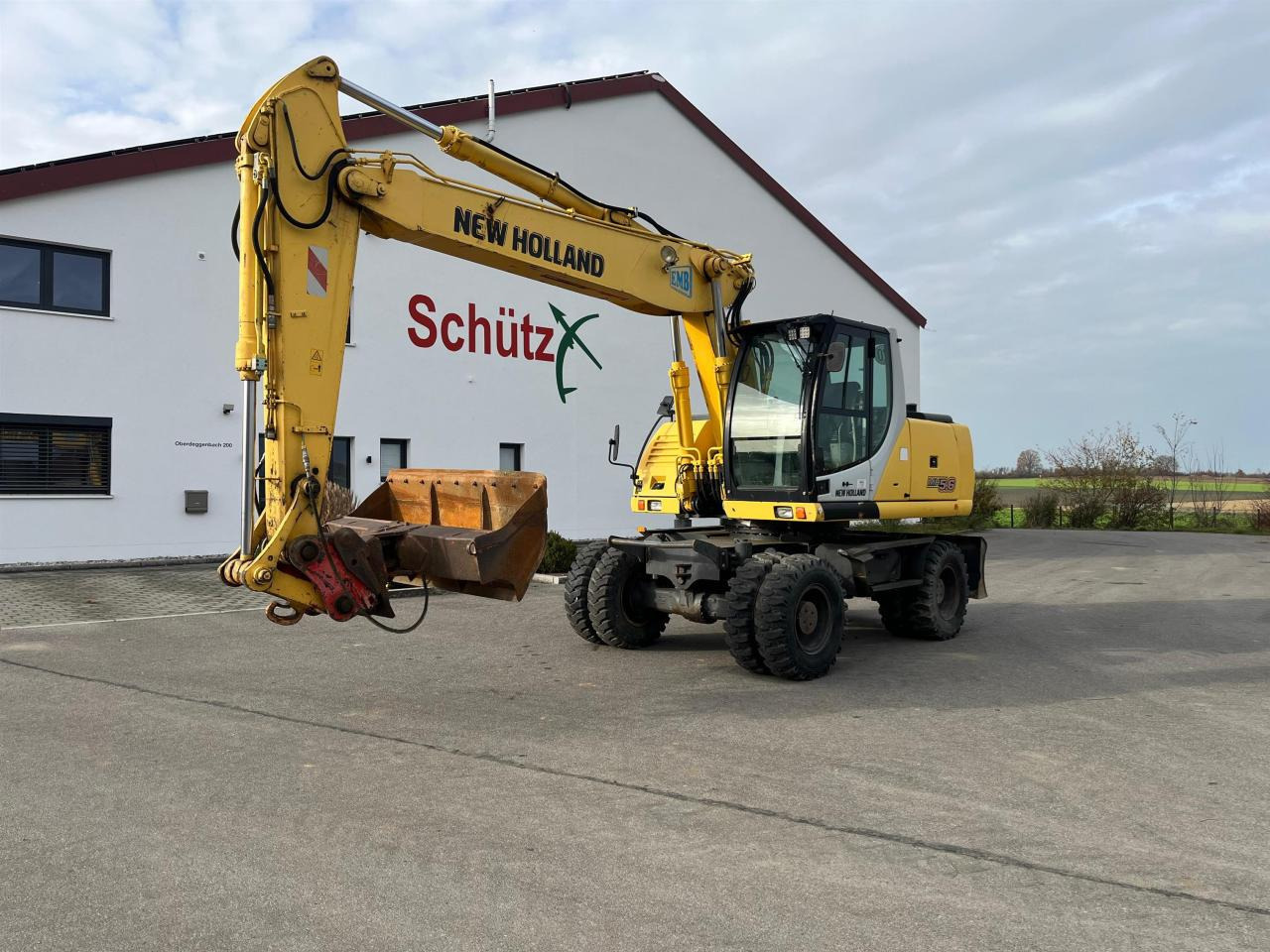 New Holland MH 5.6 inkl. Grabenlöffel, Tieflöffel - Gumikerekes kotró: 1 kép. New Holland MH 5.6 inkl. Grabenlöffel, Tieflöffel - Gumikerekes kotró: 1 kép.