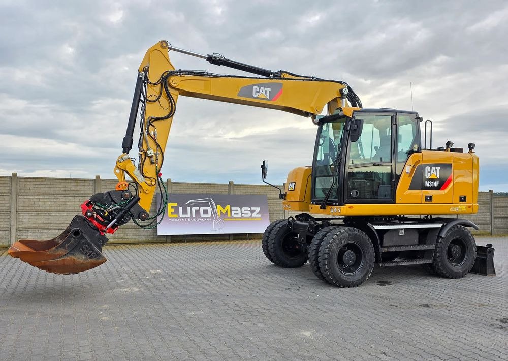 Caterpillar M314F, 2016 ROK, GŁOWICA ROTOTILT, 4400 MTH - Gumikerekes kotró: 1 kép. Caterpillar M314F, 2016 ROK, GŁOWICA ROTOTILT, 4400 MTH - Gumikerekes kotró: 1 kép.