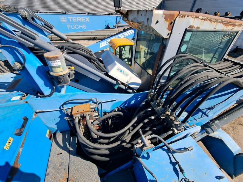 Hulladék kotró a következők szállításához hulladék Fuchs MHL 335: 9 kép. Hulladék kotró a következők szállításához hulladék Fuchs MHL 335: 9 kép.