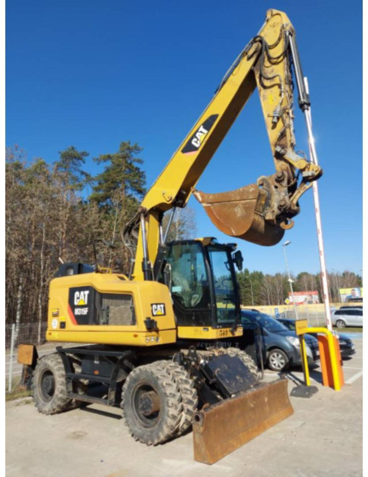 CAT M315F - Gumikerekes kotró: 2 kép. CAT M315F - Gumikerekes kotró: 2 kép.