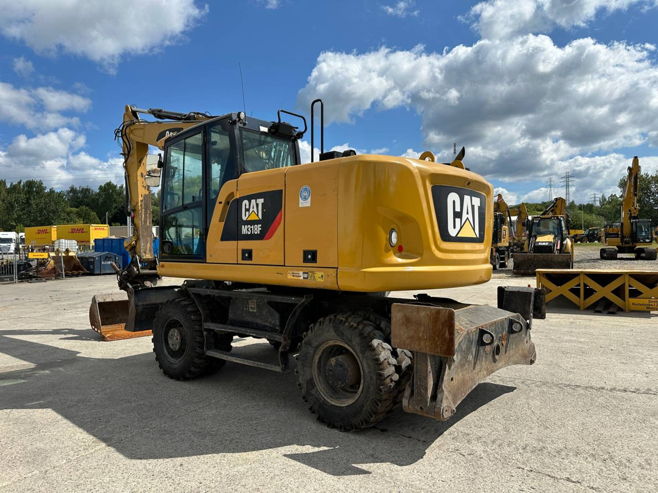 CAT M318F - Gumikerekes kotró: 4 kép. CAT M318F - Gumikerekes kotró: 4 kép.