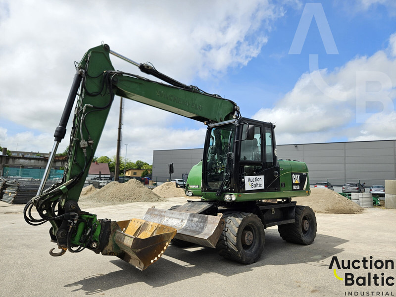 Caterpillar M315D - Gumikerekes kotró: 2 kép. Caterpillar M315D - Gumikerekes kotró: 2 kép.