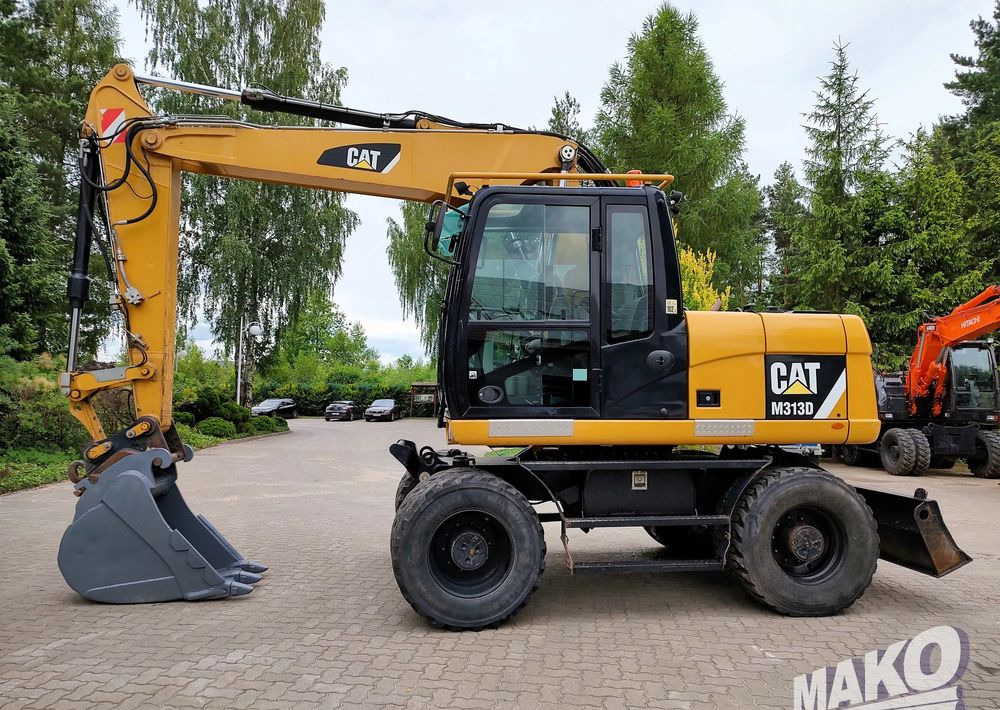Caterpillar M313D - Gumikerekes kotró: 1 kép. Caterpillar M313D - Gumikerekes kotró: 1 kép.
