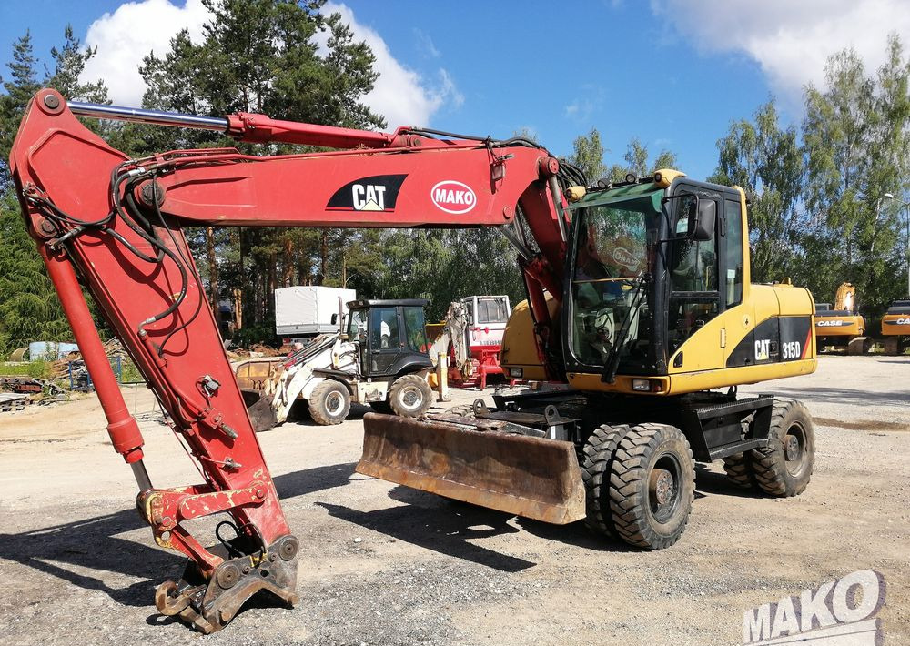 Caterpillar M315 C - Gumikerekes kotró: 1 kép. Caterpillar M315 C - Gumikerekes kotró: 1 kép.