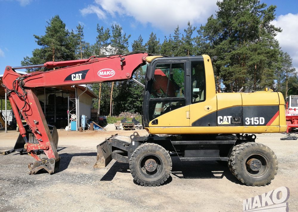 Caterpillar M315 C - Gumikerekes kotró: 2 kép. Caterpillar M315 C - Gumikerekes kotró: 2 kép.