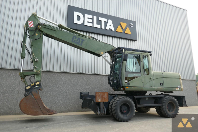 Caterpillar M318C Ex- - Gumikerekes kotró: 3 kép. Caterpillar M318C Ex- - Gumikerekes kotró: 3 kép.