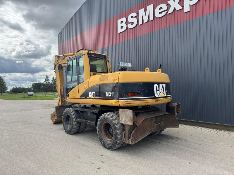 Caterpillar M 315 C - Gumikerekes kotró: 4 kép. Caterpillar M 315 C - Gumikerekes kotró: 4 kép.