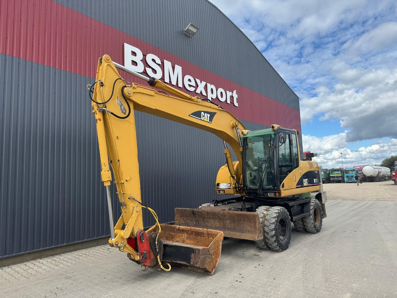 Caterpillar M 315 C - Gumikerekes kotró: 1 kép. Caterpillar M 315 C - Gumikerekes kotró: 1 kép.