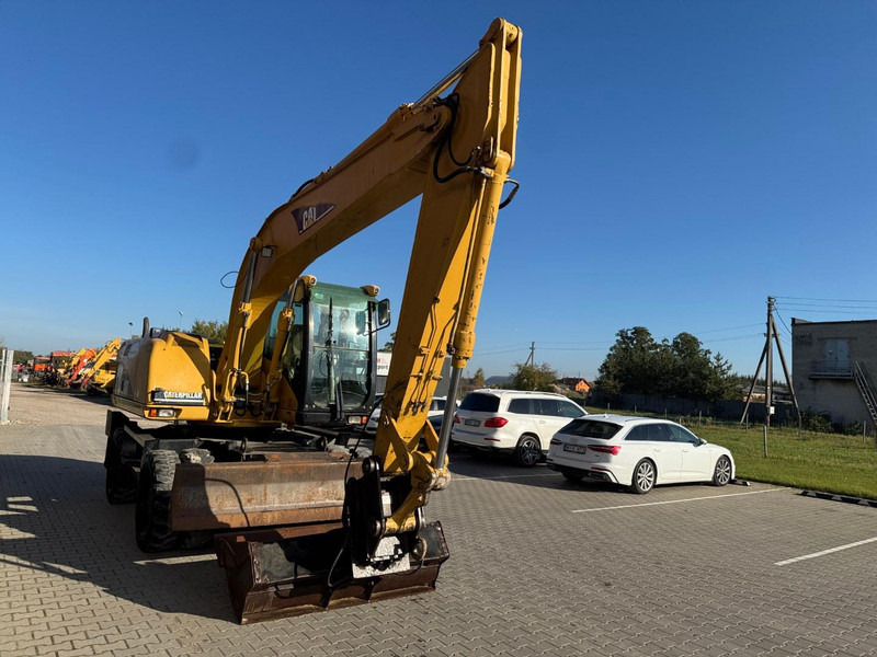 Caterpillar M 316 C - Gumikerekes kotró: 2 kép. Caterpillar M 316 C - Gumikerekes kotró: 2 kép.