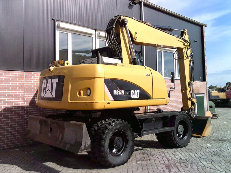 Caterpillar M316D - Gumikerekes kotró: 3 kép. Caterpillar M316D - Gumikerekes kotró: 3 kép.