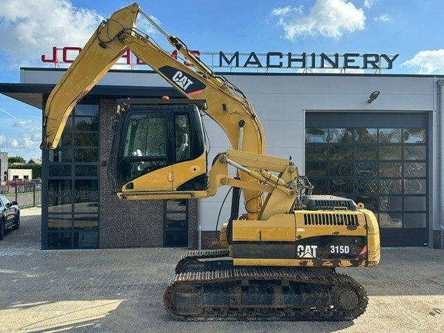 Caterpillar 315DL Material Handler - Lánctalpas kotró: 1 kép. Caterpillar 315DL Material Handler - Lánctalpas kotró: 1 kép.