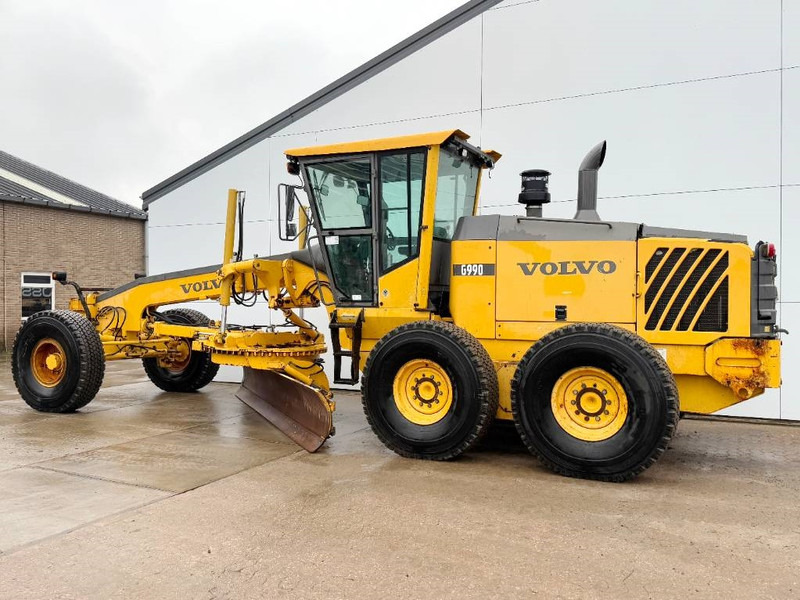 Volvo G990 - 4.85m Blade / Pushblock / Airco - Gréder: 2 kép. Volvo G990 - 4.85m Blade / Pushblock / Airco - Gréder: 2 kép.