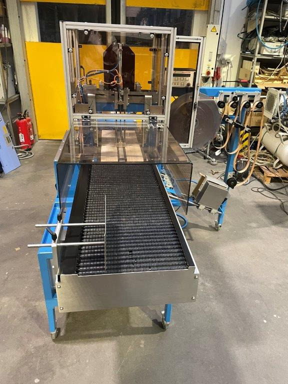 ATS Tanner UltraSonic US 2000-AB transit banding machine with pneumatic product hold-down and infeed roller table - Csomagológép: 4 kép. ATS Tanner UltraSonic US 2000-AB transit banding machine with pneumatic product hold-down and infeed roller table - Csomagológép: 4 kép.