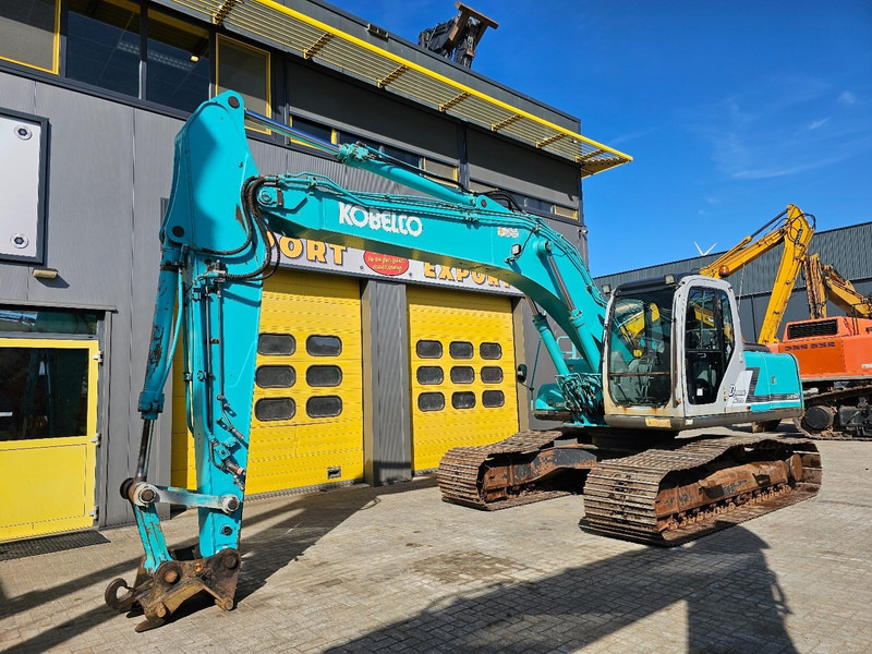Kobelco SK210LC-6 - Lánctalpas kotró: 2 kép. Kobelco SK210LC-6 - Lánctalpas kotró: 2 kép.