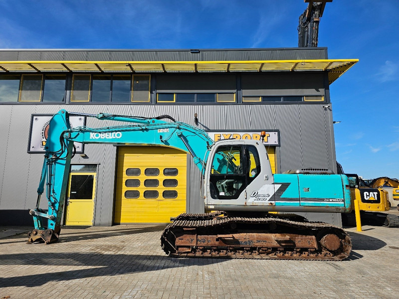 Kobelco SK210LC-6 - Lánctalpas kotró: 1 kép. Kobelco SK210LC-6 - Lánctalpas kotró: 1 kép.