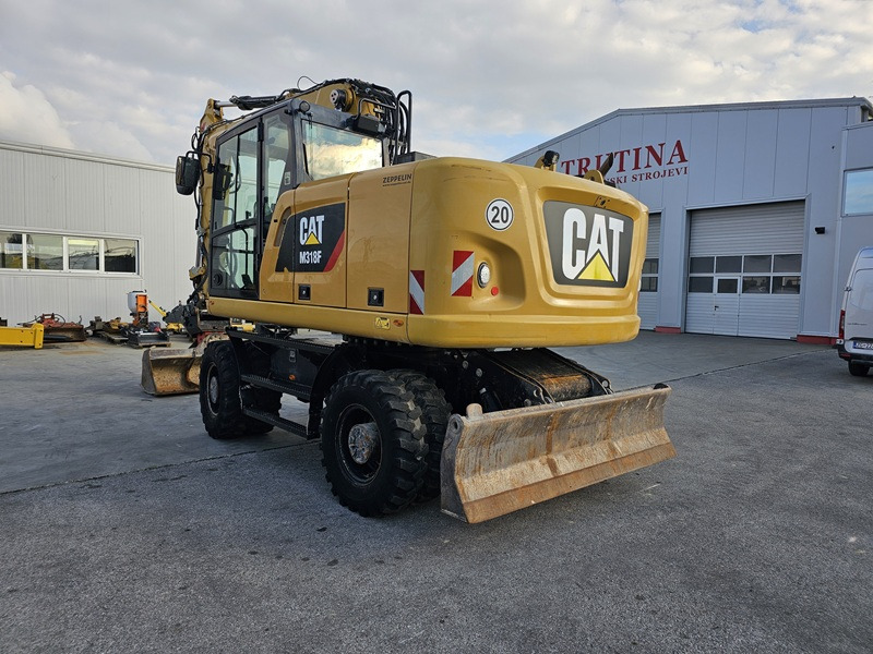 CATERPILLAR M318F - Gumikerekes kotró: 2 kép. CATERPILLAR M318F - Gumikerekes kotró: 2 kép.