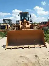 Used Construction Caterpillar 966h Wheeled Loader Cat966h Cat966 Wheel Loader in Shanghai - Gumikerekes homlokrakodó: 4 kép. Used Construction Caterpillar 966h Wheeled Loader Cat966h Cat966 Wheel Loader in Shanghai - Gumikerekes homlokrakodó: 4 kép.