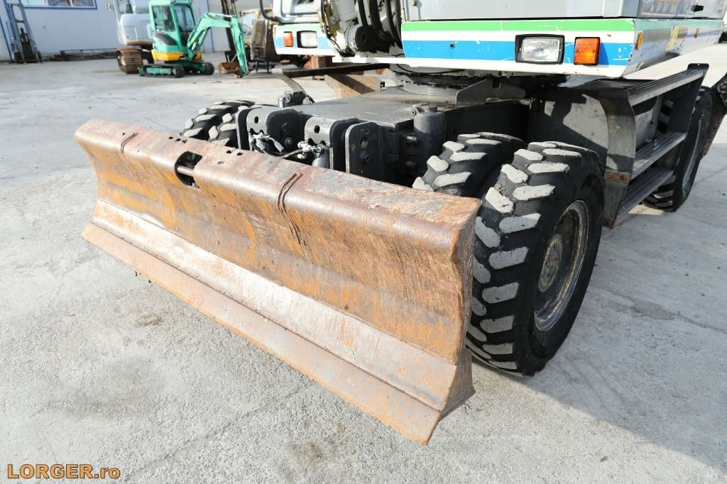 Gumikerekes kotró New Holland MH 6.6 + Sandvic Hammer: 10 kép.