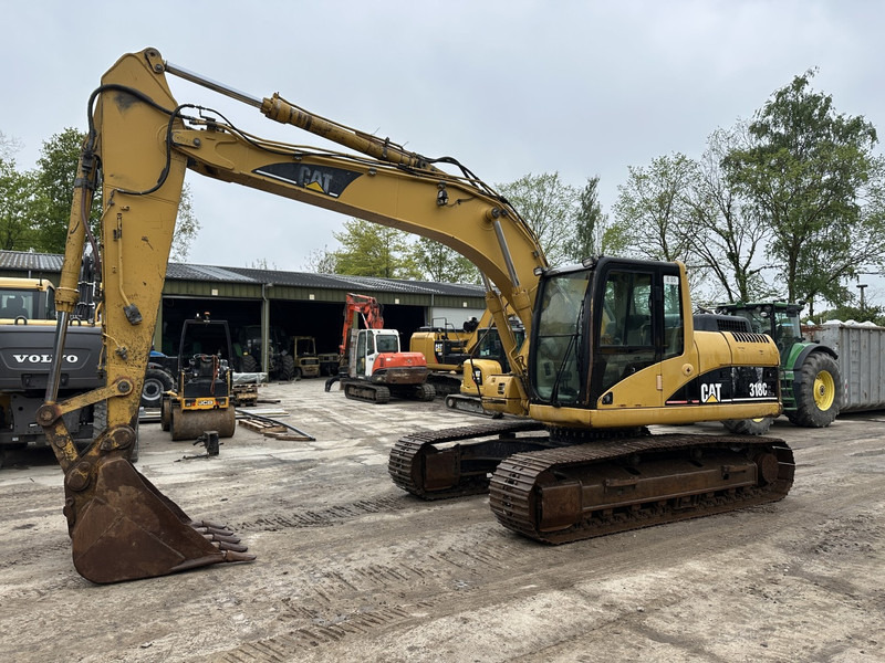 Caterpillar 318 CL (not 320CL - 325CL) - Lánctalpas kotró: 1 kép. Caterpillar 318 CL (not 320CL - 325CL) - Lánctalpas kotró: 1 kép.