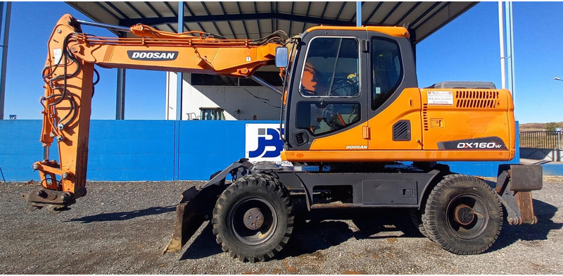 Doosan DX140W-3 - Gumikerekes kotró: 1 kép. Doosan DX140W-3 - Gumikerekes kotró: 1 kép.