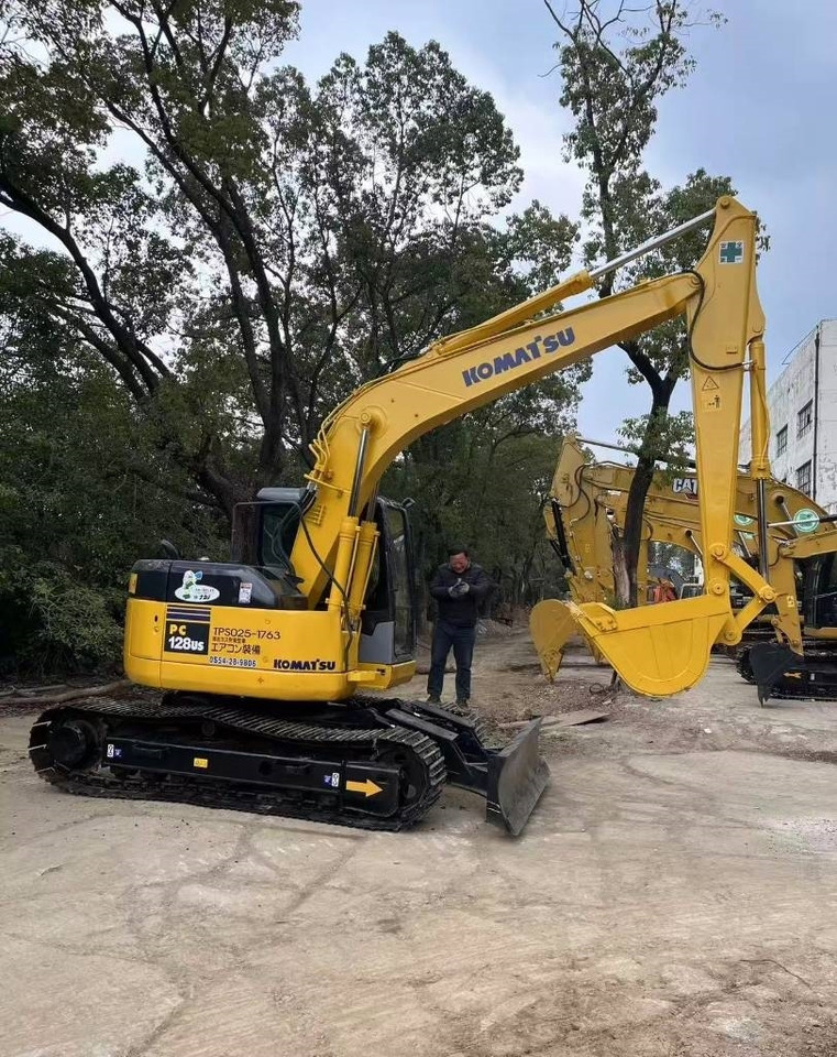 Komatsu 128 US - Lánctalpas kotró: 1 kép. Komatsu 128 US - Lánctalpas kotró: 1 kép.
