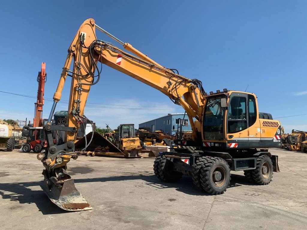 Hyundai Robex 180 W-9 A - Gumikerekes kotró: 1 kép. Hyundai Robex 180 W-9 A - Gumikerekes kotró: 1 kép.