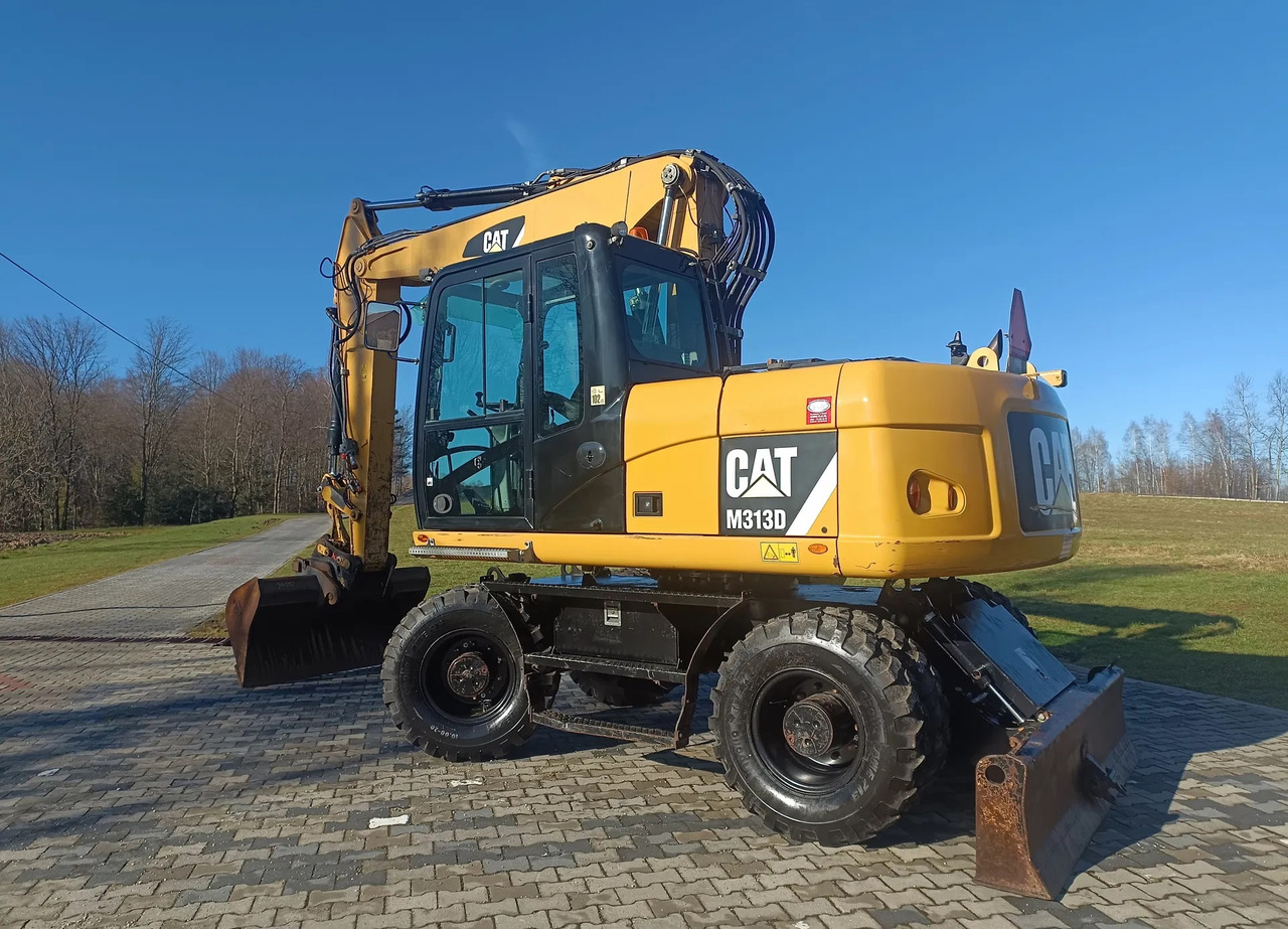 CATERPILLAR M313D - Gumikerekes kotró: 1 kép. CATERPILLAR M313D - Gumikerekes kotró: 1 kép.