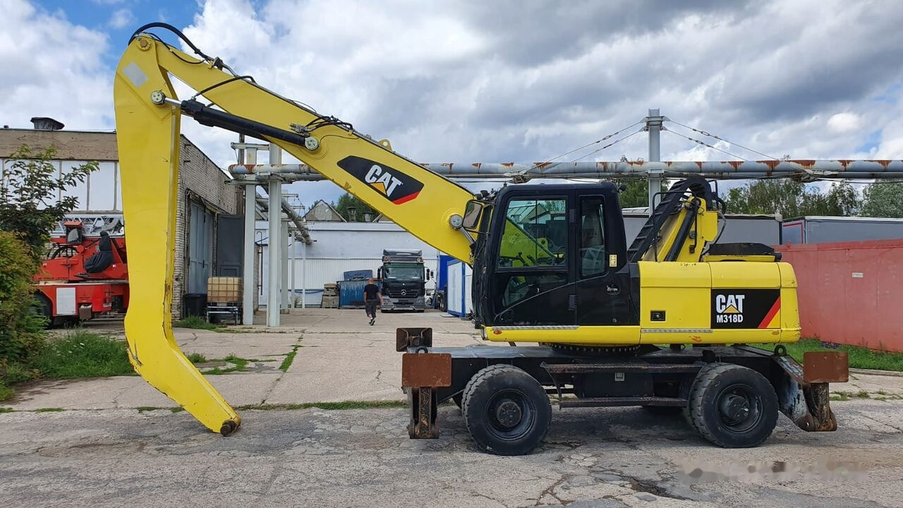 Caterpillar M 318 D MH - Hulladék kotró: 1 kép. Caterpillar M 318 D MH - Hulladék kotró: 1 kép.