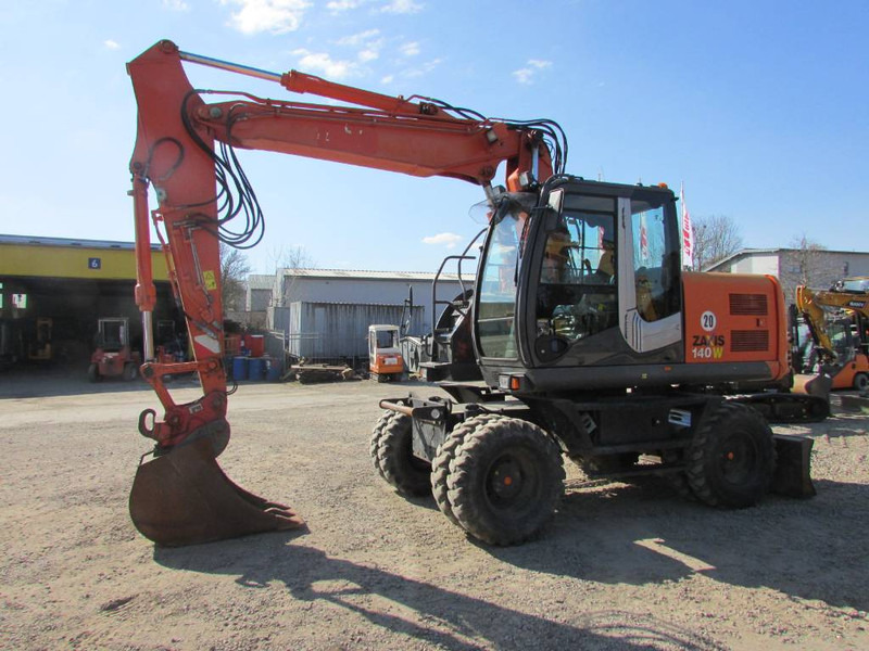 Hitachi ZX 140 W-3 Mobilbagger 45.000 EUR / Klima - Gumikerekes kotró: 1 kép. Hitachi ZX 140 W-3 Mobilbagger 45.000 EUR / Klima - Gumikerekes kotró: 1 kép.