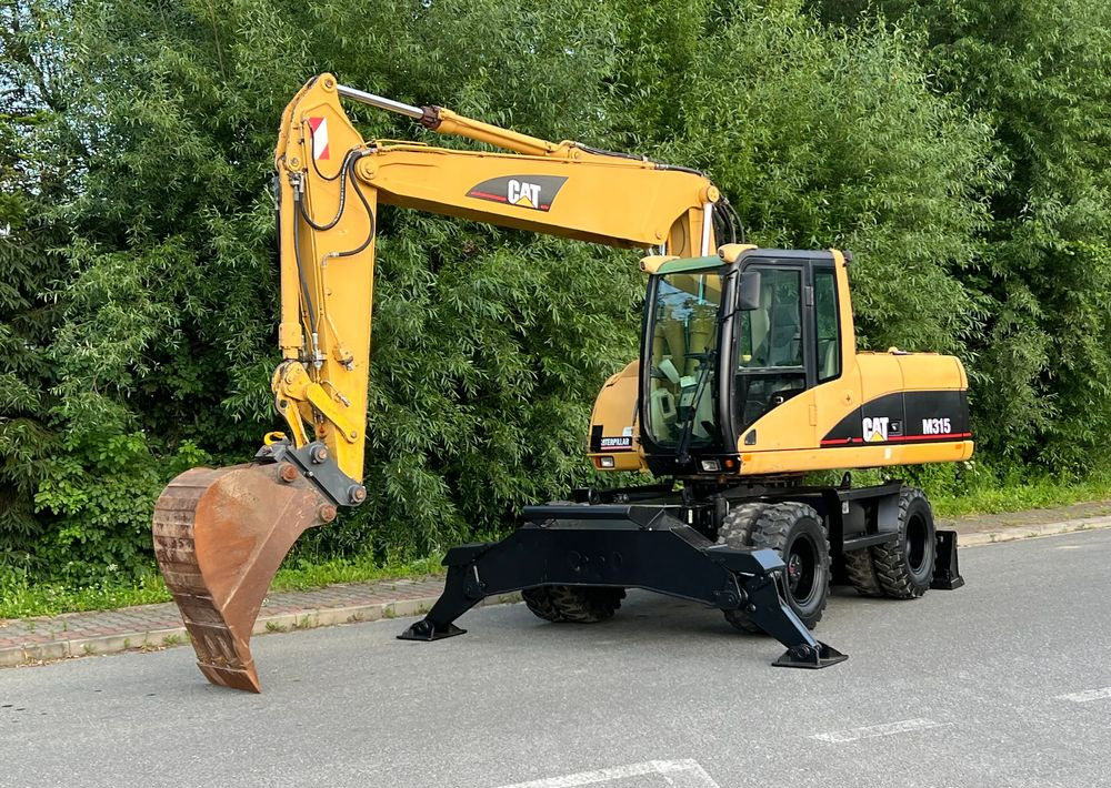 Caterpillar CAT M315C CATERPILLAR SPROWADZONY Bardzo Dobry Stan - Gumikerekes kotró: 1 kép. Caterpillar CAT M315C CATERPILLAR SPROWADZONY Bardzo Dobry Stan - Gumikerekes kotró: 1 kép.