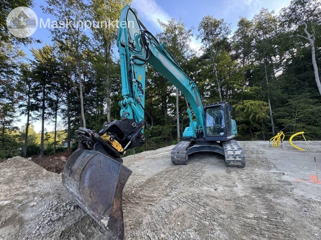 Kobelco SK 210 LC-10 - Lánctalpas kotró: 5 kép. Kobelco SK 210 LC-10 - Lánctalpas kotró: 5 kép.