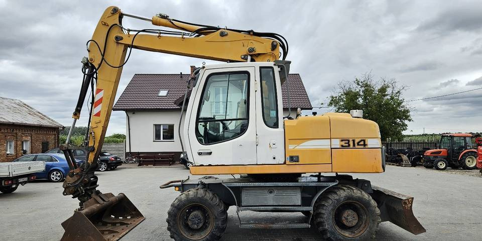 Koparka kołowa Liebherr A314 Litronic 9350 h+ 5 łyżek kołówka - Gumikerekes kotró: 1 kép. Koparka kołowa Liebherr A314 Litronic 9350 h+ 5 łyżek kołówka - Gumikerekes kotró: 1 kép.