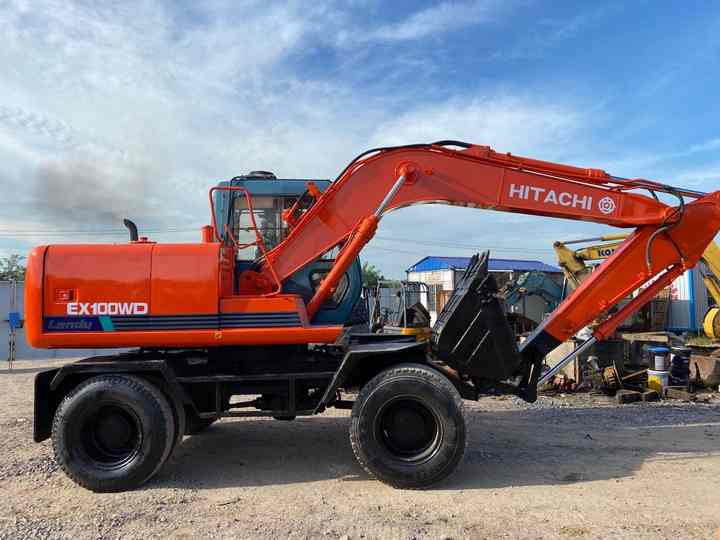 Used Hitachi Ex100WD Wheel Excavator for Sale Japan Made Hitachi Ex100wd Wheeled Excavator for Sale - Gumikerekes kotró: 2 kép. Used Hitachi Ex100WD Wheel Excavator for Sale Japan Made Hitachi Ex100wd Wheeled Excavator for Sale - Gumikerekes kotró: 2 kép.