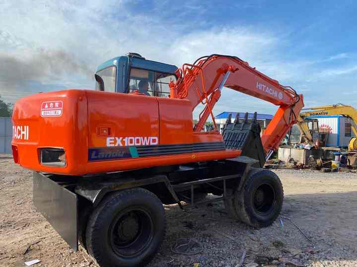 Used Hitachi Ex100WD Wheel Excavator for Sale Japan Made Hitachi Ex100wd Wheeled Excavator for Sale - Gumikerekes kotró: 4 kép. Used Hitachi Ex100WD Wheel Excavator for Sale Japan Made Hitachi Ex100wd Wheeled Excavator for Sale - Gumikerekes kotró: 4 kép.
