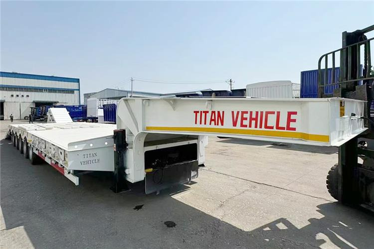 TITAN 5 Axle 100 Ton Low Bed Trailer for Sale In Tanzania - Félpótkocsi mélybölcsős: 5 kép. TITAN 5 Axle 100 Ton Low Bed Trailer for Sale In Tanzania - Félpótkocsi mélybölcsős: 5 kép.