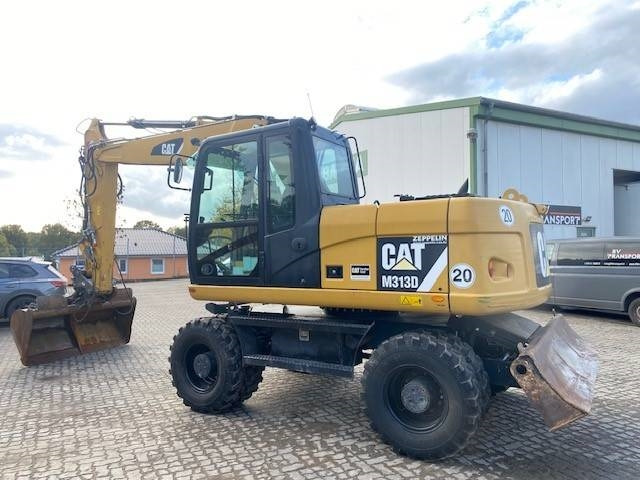 Cat M 313 D MIETE / RENTAL (12005587) - Gumikerekes kotró: 2 kép. Cat M 313 D MIETE / RENTAL (12005587) - Gumikerekes kotró: 2 kép.