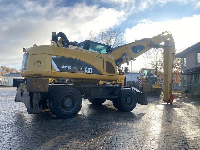 Hulladék kotró a következők szállításához hulladék Cat M 318 D MH (12005607): 6 kép. Hulladék kotró a következők szállításához hulladék Cat M 318 D MH (12005607): 6 kép.