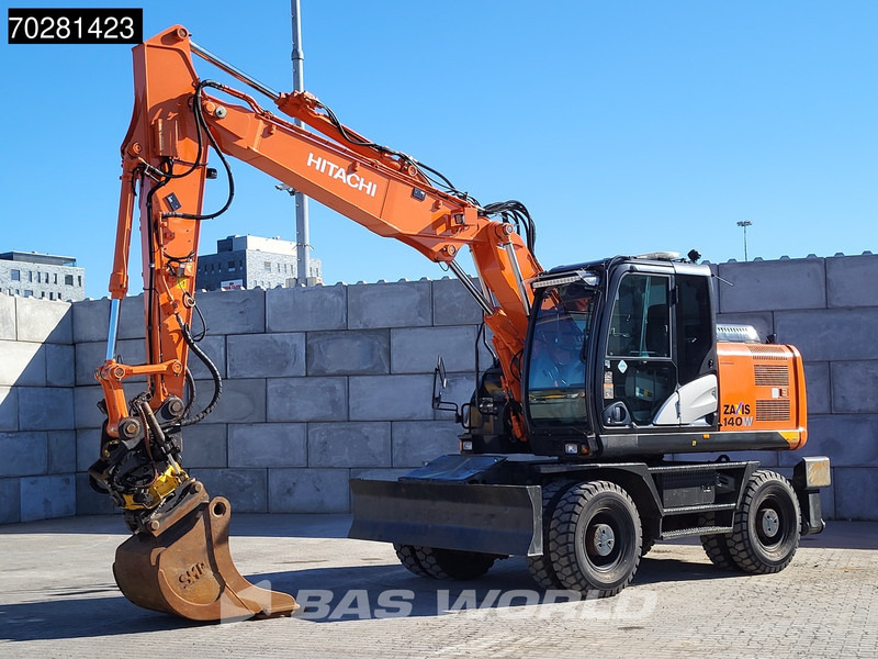 Hitachi ZX140W -5 OUTRIGGERS + BLADE - Gumikerekes kotró: 2 kép. Hitachi ZX140W -5 OUTRIGGERS + BLADE - Gumikerekes kotró: 2 kép.