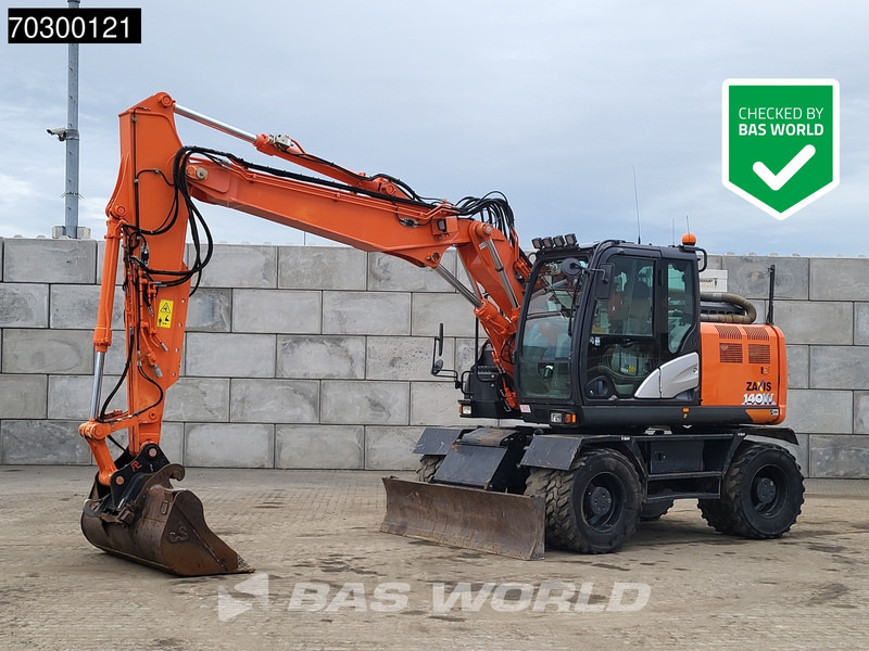 Hitachi ZX140W -6 - Gumikerekes kotró: 1 kép. Hitachi ZX140W -6 - Gumikerekes kotró: 1 kép.