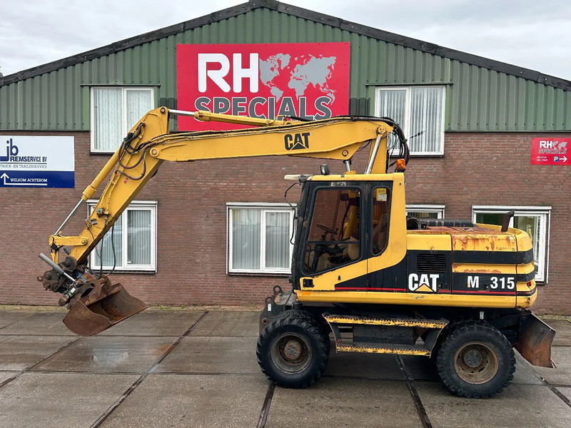 Caterpillar M315 +ROTO CE - Gumikerekes kotró: 1 kép. Caterpillar M315 +ROTO CE - Gumikerekes kotró: 1 kép.
