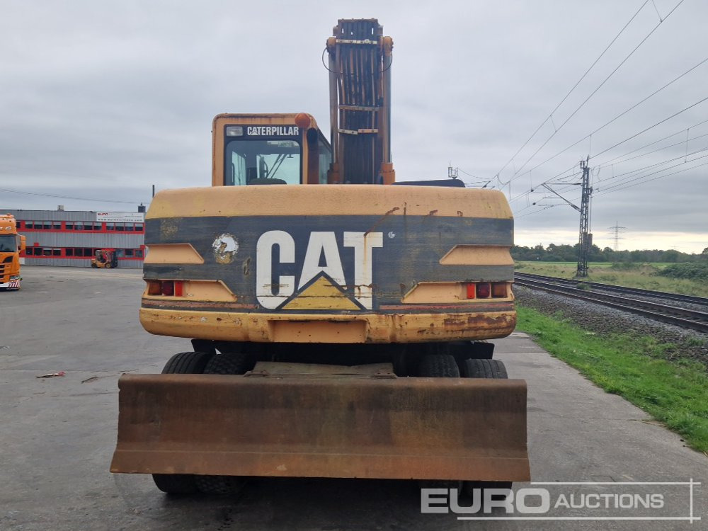 CAT M315 - Gumikerekes kotró: 4 kép. CAT M315 - Gumikerekes kotró: 4 kép.