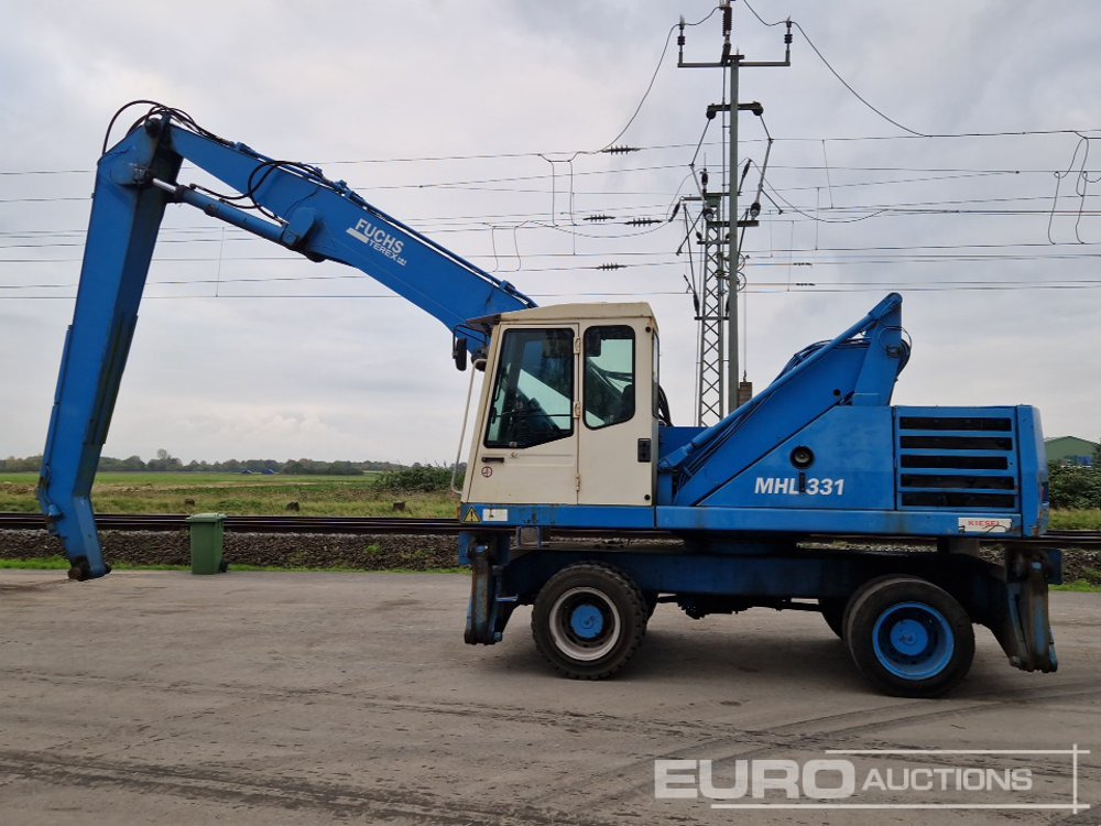 Fuchs MHL331 - Gumikerekes kotró: 2 kép. Fuchs MHL331 - Gumikerekes kotró: 2 kép.