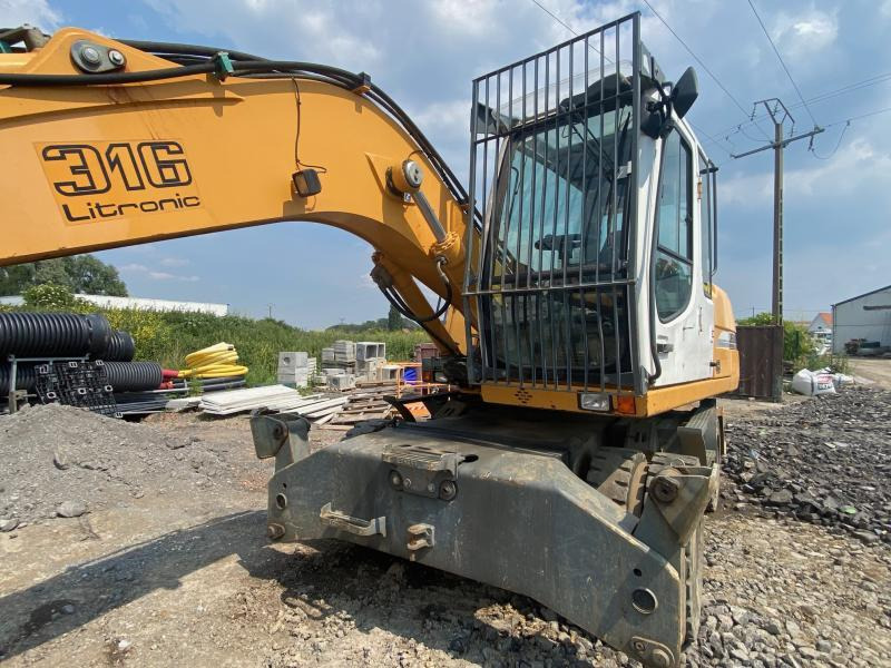 Gumikerekes kotró Liebherr A316Litronic: 12 kép.