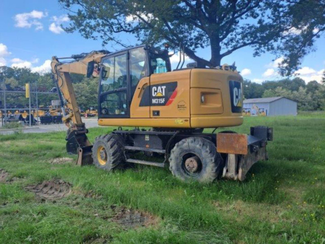 CAT M315F IVC - Gumikerekes kotró: 4 kép. CAT M315F IVC - Gumikerekes kotró: 4 kép.